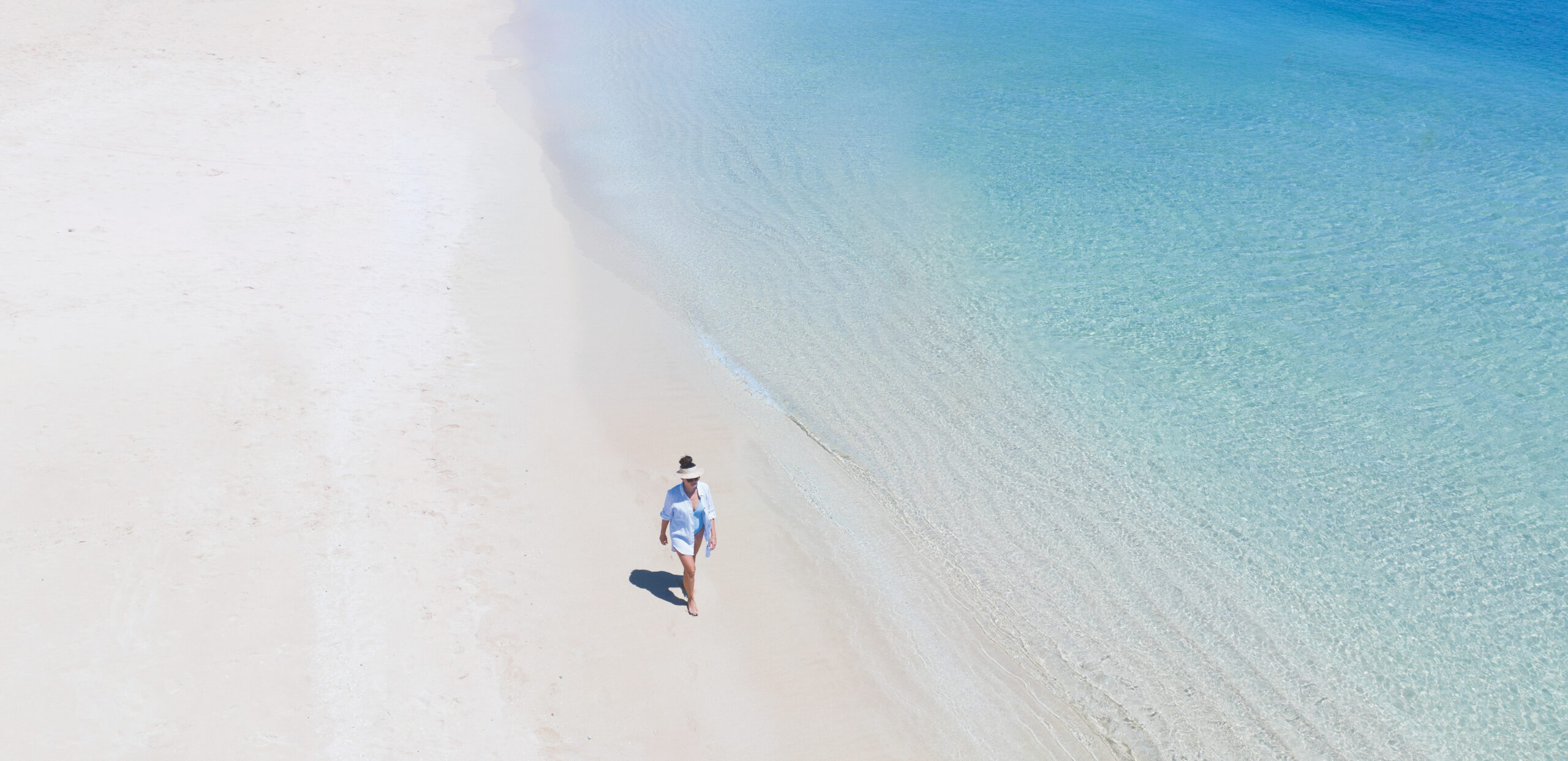 Aerial shot of one person walking on the beach